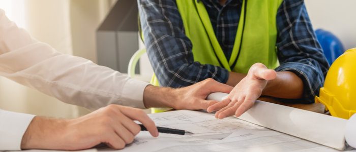Homeowner discussing a contract with tradesperson.